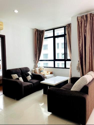 a living room with two couches and a table at Lake view homestay in Serdang