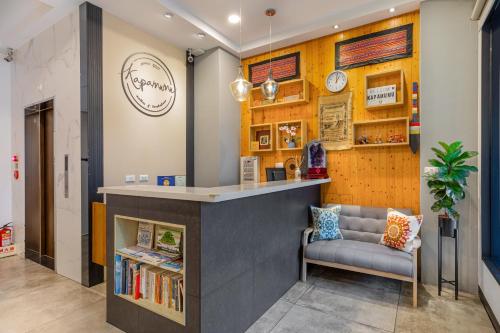 a bar in a library with a chair and books at Kapamumu b&b in Yuchi