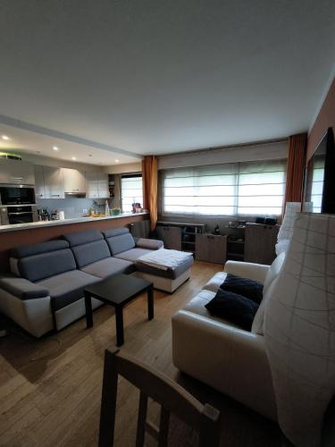 a large living room with couches and a kitchen at Le Clichy - 4 people - Metro 13 & 14 - Paris in Clichy