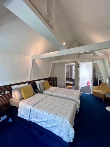 a bedroom with a large bed and a couch at Amsterdam 4 Holiday GuestRooms in Amsterdam