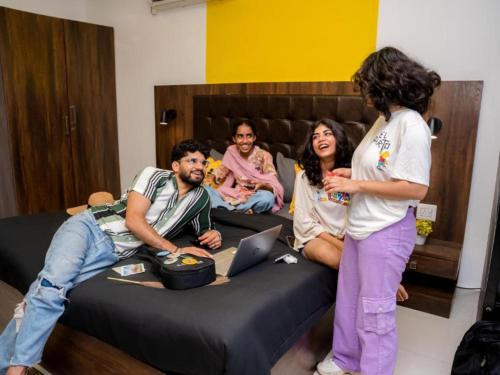a group of people standing around a bed at The Hosteller Gokarna in Gokarna