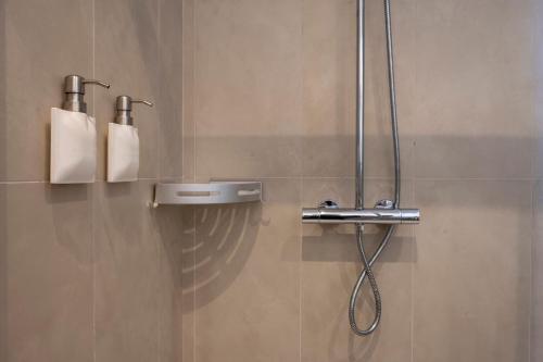 a shower in a bathroom with two rolls of toilet paper at New Roman Experience in Rome