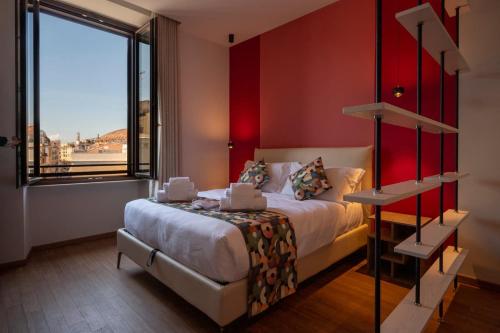 a bedroom with a bed and a large window at New Roman Experience in Rome