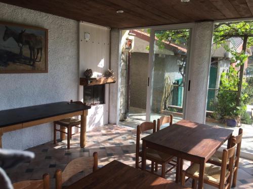 a patio with tables and chairs and a horse outside at Agriturismo OlivArancio in Leivi