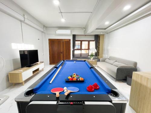 a living room with a pool table in the middle at Lilly house near Krabi Airport with Free Airport Shuttle in Krabi