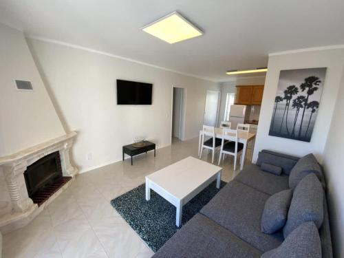 a living room with a couch and a table at Casa Melli with Sunset Oceanview Terrace in Lourinhã