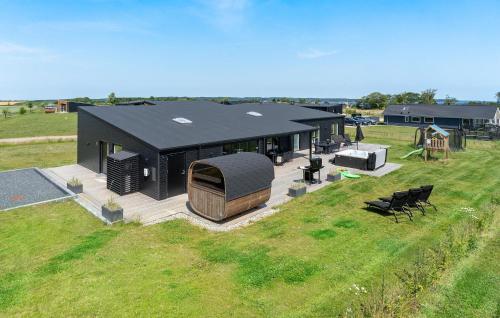 an overhead view of a black house in a field at Beautiful Home In Børkop With Sauna in Børkop