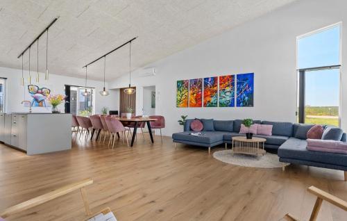 a living room with a blue couch and a table at Beautiful Home In Børkop With Sauna in Børkop