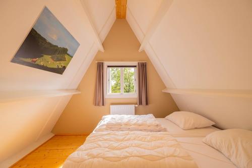 a bedroom with a white bed in a attic at Hidden jewel in Durbuy's forest in Durbuy