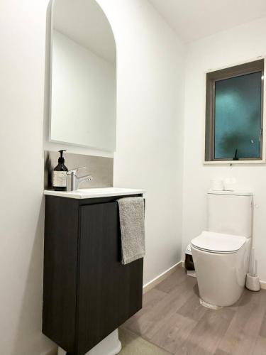 a bathroom with a sink and a toilet at Large warm 4BRM family recharge in Halswell - Netflix, Massage chair in Halswell