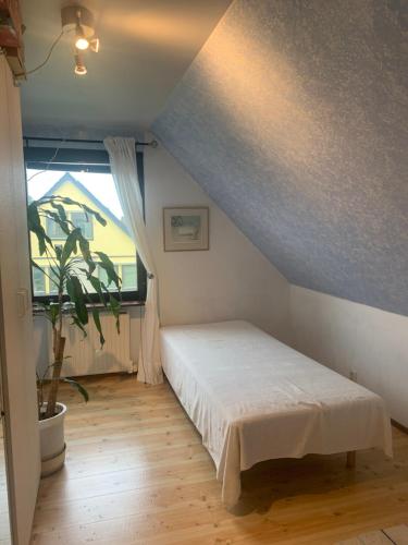 a bedroom with a bed and a large window at Cozy room and rooms in a town in Staffanstorp