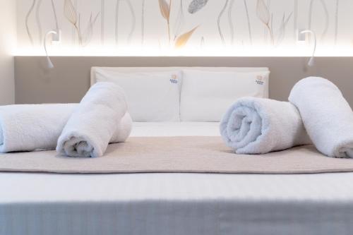 a group of towels on a bed in a room at Ammos Korali in Olympiaki Akti
