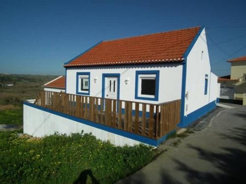 a small white house with a wooden deck at West Country House in Lourinhã