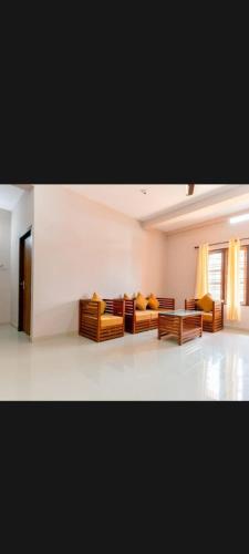 a living room with two couches and a table at Finenest homes kalpetta in Kalpetta