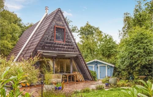 a thatch roofed thatch house with a deck at Lovely Home In Kerschenbach With Wifi in Kerschenbach