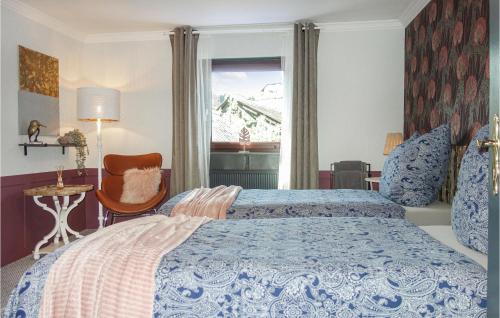 a bedroom with a bed and a chair and a window at Cozy Home In Ulmen With Kitchen in Ulmen