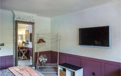 a bedroom with purple walls and a tv on the wall at Cozy Home In Ulmen With Kitchen in Ulmen