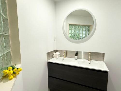a bathroom with a sink and a mirror at Large warm 4BRM family recharge in Halswell - Netflix, Massage chair in Halswell