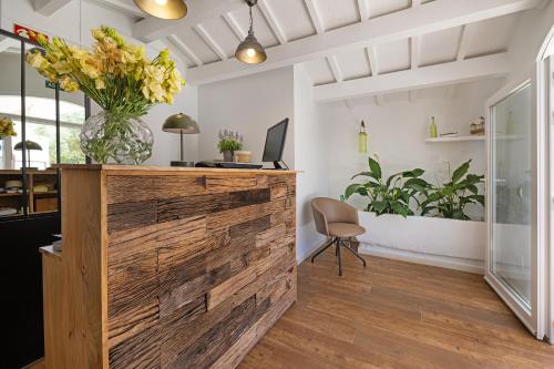 an office with a wooden wall with a vase of flowers at Agroturismo Santa Mariana in Alaior