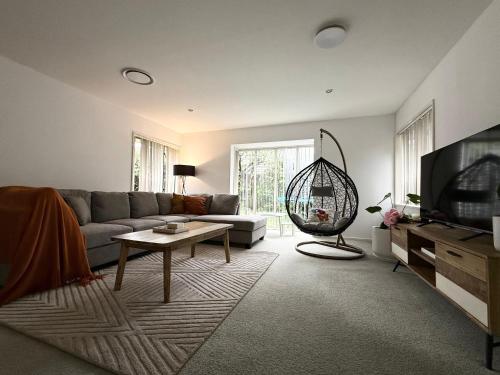 a living room with a couch and a tv at Large warm 4BRM family recharge in Halswell - Netflix, Massage chair in Halswell