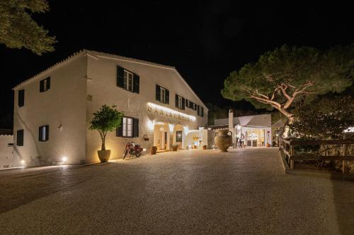 a large white building with lights on it at night at Agroturismo Santa Mariana in Alaior