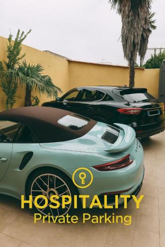 two expensive cars parked in a parking lot at Zeta Boutique in Caserta