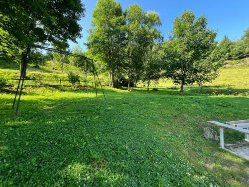 a park with a bench in the middle of a field at Gîte Au Creux Du Moulin in Bussang