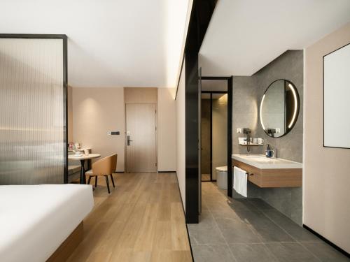 a hotel room with a bed and a bathroom at Starway Hotel Guilin Two Rivers and Four Lakes Scenic Area in Guilin