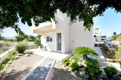 a villa with a view of the garden at Seraina House in Pastida