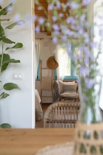 a living room with a table with a vase of flowers at Una Scelta, more than just a room in Soriano nel Cimino