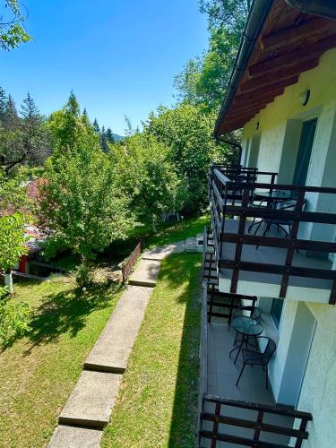 a balcony with chairs and tables on a house at Casa Flori de Sare in Slănic
