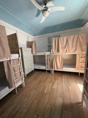 a room with several bunk beds and a ceiling at Orange Terrace Hostel in Albufeira