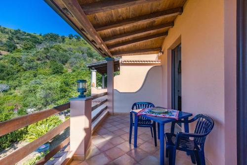 a balcony with a table and chairs on it at Casa del Mandarino Gioiosa Marea in Gioiosa Marea