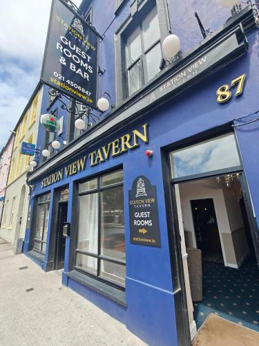 a blue building with a yellow view tavern sign on it at Station View Tavern in Cork