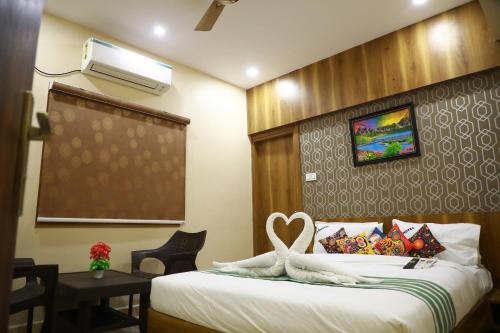 a hotel room with a bed with a heart on it at GM hotel in Tirupati