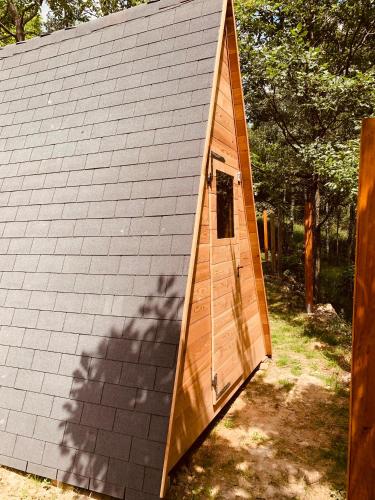 a wooden shed with a door on the side of it at Campeggio Cianabie in Sampeire