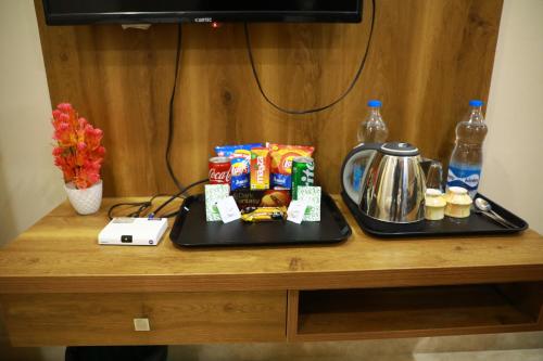 a table with a tray with food and drinks on it at GM hotel in Tirupati