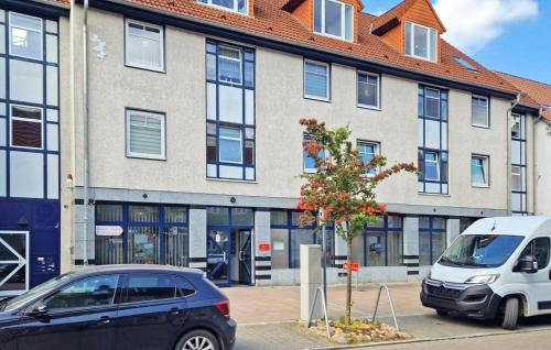 two cars parked in front of a building at Cozy Apartment In Malchow With Wifi in Malchow