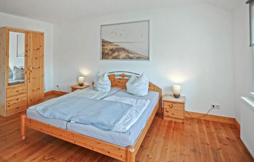 a bedroom with a bed with blue sheets and two lamps at Ferienwohnung Ankershagen in Friedrichsfeld