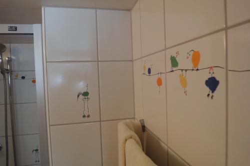 a bathroom with birds stickers on the wall at Hotel Gerig in Wassen