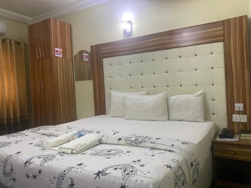 a bed with two pillows on top of it at Beamgate Hotels & Apartments, Abak Rd, Uyo in Uyo