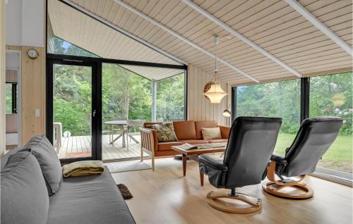 a living room with a couch and two chairs at Holiday Home Højdevej in Vejby