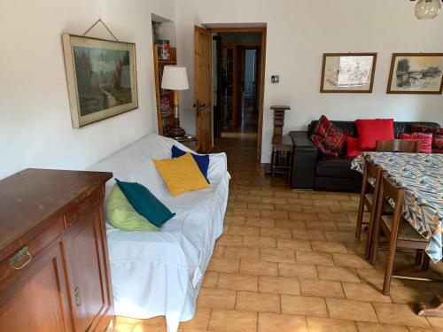 a living room with a white couch with colorful pillows at bellagio nel bosco in Bellagio