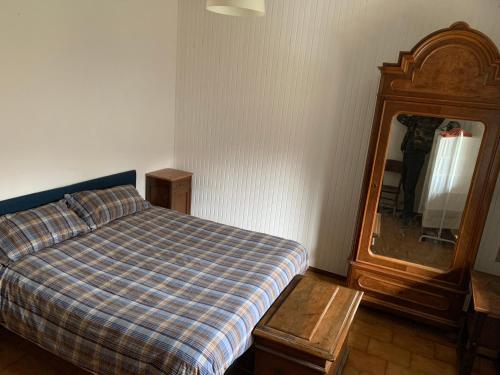 a bedroom with a bed and a dresser and a mirror at bellagio nel bosco in Bellagio