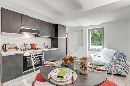 a kitchen with a table with plates of food on it at Residenza Quadrifoglio in Casalzuigno