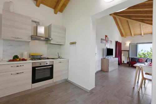 a kitchen with white cabinets and a stove top oven at Residenza Quadrifoglio in Casalzuigno