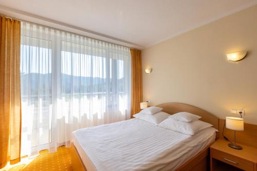 Postel nebo postele na pokoji v ubytování Hotel Perła Południa
