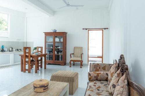 a living room with a couch and a table at Villa 83 in Nedimale