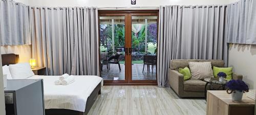 a hotel room with a bed and a couch at Denika's Suites in Puerto Princesa City