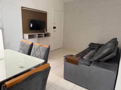 a living room with a couch and a table at Apto 2 quarto Completo com Vaga in Contagem